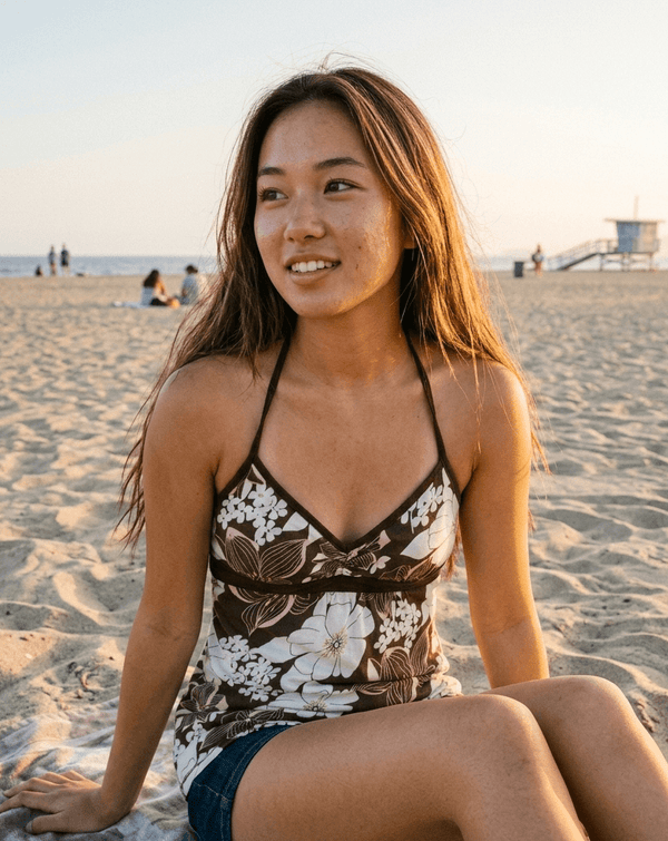 Brown tropical floral halter top on model
