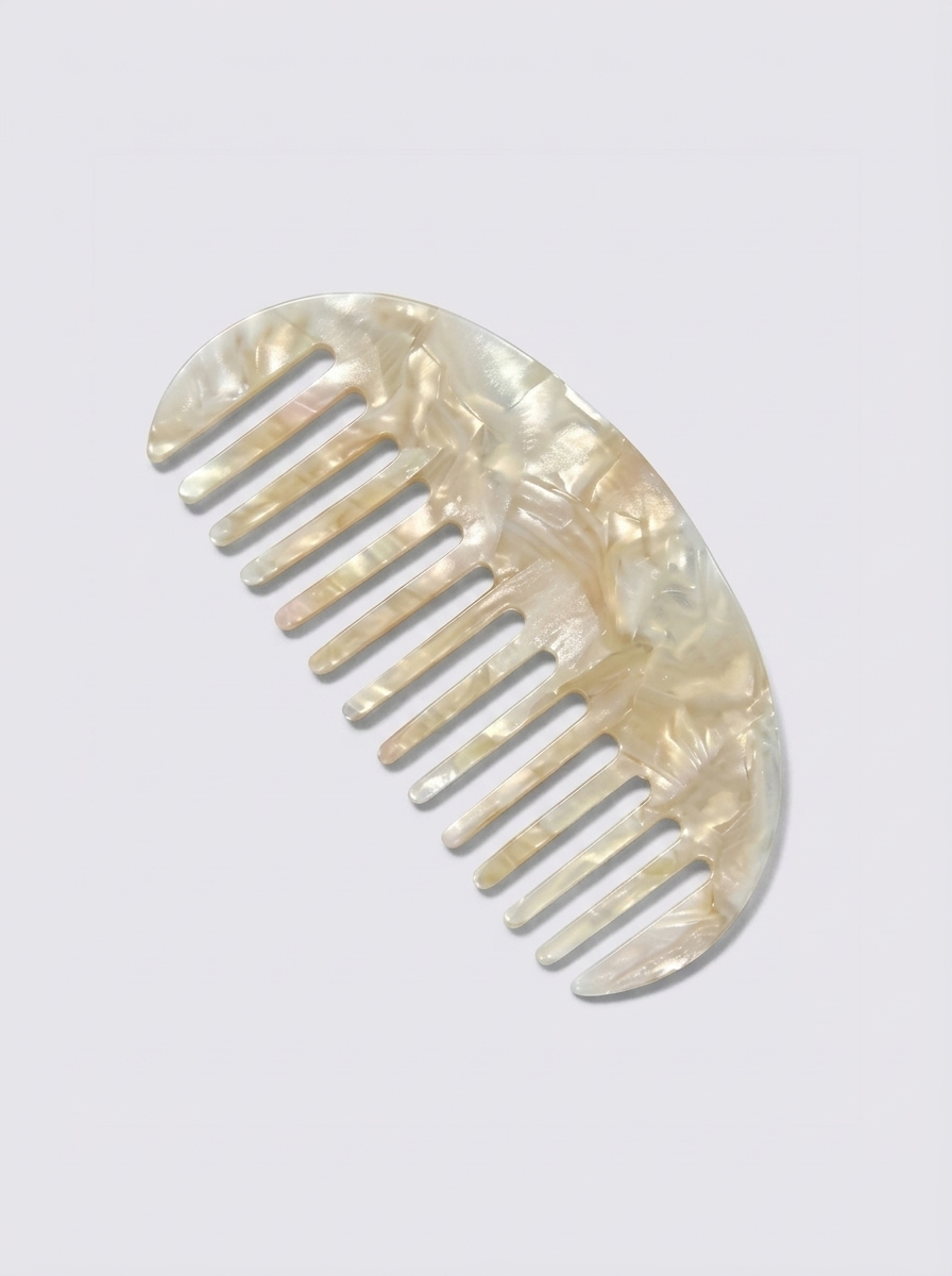 Half moon acetate hair comb on surface - detail shot