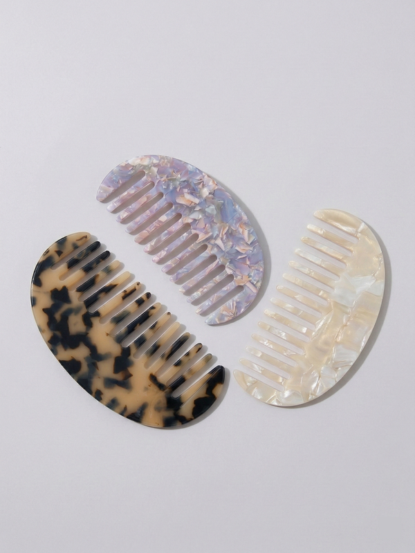 Half moon acetate hair comb on surface