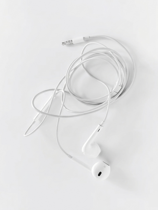 Classic white wired earbuds on white background