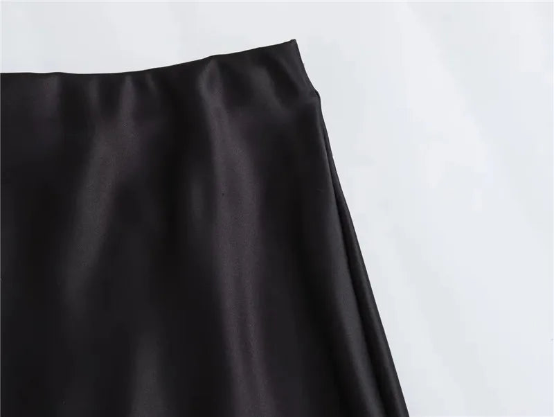 Black satin midi skirt on model - styling view