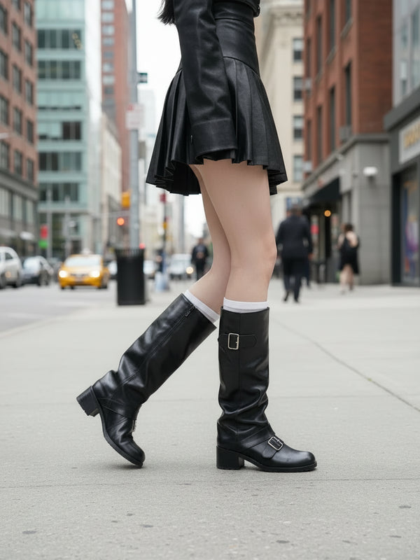 Buckled knee high motorcycle boots on model