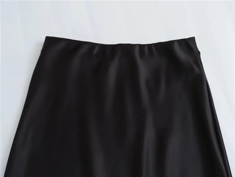 Black satin midi skirt on model - detail shot