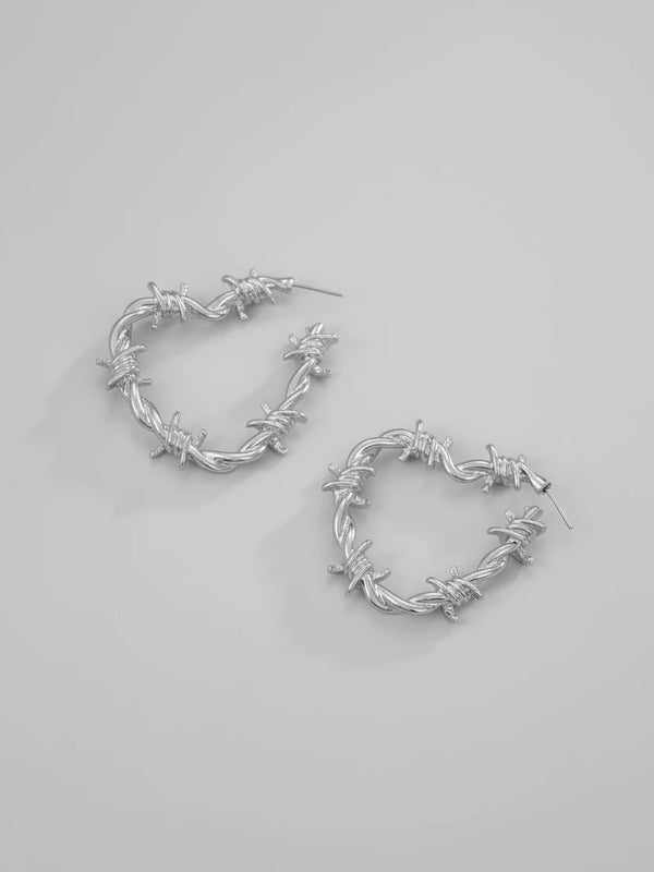 Barbed wire heart hoop earrings close up