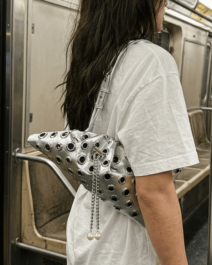 Drawstring rivet studded shoulder bag